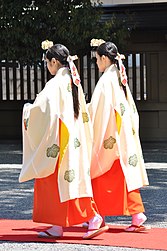 Two young Shinto priestesses walking