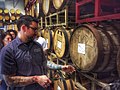Image 1A beer sommelier tapping a barrel for a taste at Nebraska Brewing Company (from Craft beer)