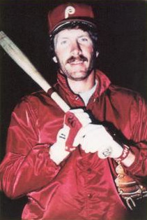 Portrait of Phillies' third baseman Mike Schmidt looking at the camera and holding a bat across his chest