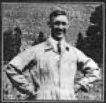 Blurred, half-length portrait of a smiling man, standing with his hands on his hips