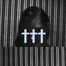A black-and-white photo of a person's head, obscured in darkness, stood between two panels of striped material, with the band's logo in light blue over top of the person's face.