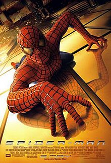 Spider-Man in his suit crawling over a building and looking towards the viewer. Below of him is New York City, the film's title, credits, and release date.