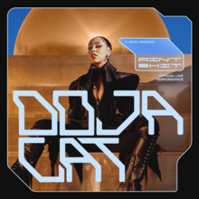 Doja Cat in an all-black outfit, sitting on a gold bench with a large gold orb behind her. Her name, printed in all-caps letters, stands on the lower half of the image. On the right side of the cover art lies text that reads "A Vevo Original / Ain't Shit / Official Live Performance".