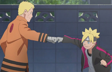An image of a father and his son performing a fist bump