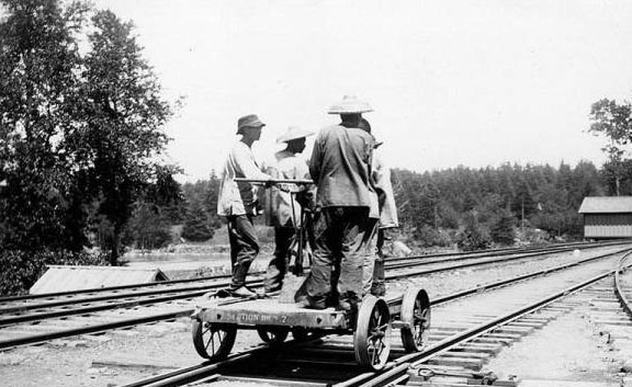Labourers on a railroad handcar.