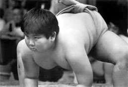 Assuming the classis sumo stance, a young boy puts on his best “game face” during competition.