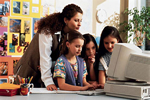 Teacher and children with computer