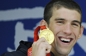 Michael Phelps stands on the podium after winning the men's 4 x 100m medley relay. He has become the only person to win eight gold medals at the same Olympic Games.