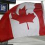 A Canadian flag flies from the window of a General Motors vehicle at a car dealership in Toronto Dec. 12, 2008.