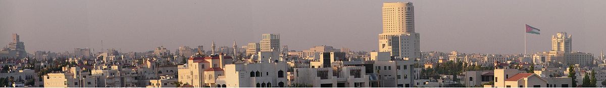 A panoramic view of Amman's skyline in 2003, showing several landmarks including the Al-Iskan Bank Building, The Tower, Raghadan Flagpole,Le Royal Hotel, Zara Towers and the King Abdullah I Mosque