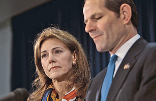 New York Governor Eliot Spitzer (R) announces his resignation as his wife Silda Wall Spitzer stands next to him March 12, 2008 in New York City.