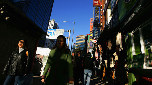 Pedestrians pictured in Seoul's Myungdong shopping district on November 21, 2008