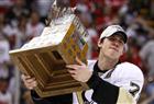 Pittsburgh Penguins forward Evgeni Malkin hoists the Conn Smythe Trophy after defeating the Detroit Red Wings in Game 7 of the NHL Stanley Cup Final hockey series in Detroit, Michigan, June 12, 2009.