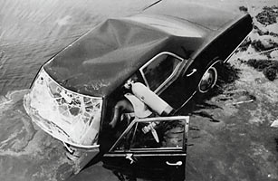Divers try to raise the car belonging to Senator Edward Kennedy in which he was seriously injured and his passenger Mary Jo Kopechne was