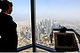 A woman looks over the city view at an observation point on the observation deck of the Burj Dubai tower, on Level 124 in Dubai.