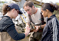 Instructor and students study collected field samples