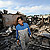 A man walks through the rubble of destroyed houses on Yeonpyeong Island, South Korea, following artillery exchange between North and South Korea on November 24, 2010.