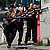 Policemen aim their weapons as they cover from shooting during an operation against drug traffickers at the Vila Cruzeiro slum in Rio de Janeiro, Brazil, Thursday Nov. 25, 2010.