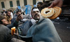 Food is offered to a wounded anti-government protester in Tahrir Square, Egypt