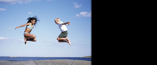 Travel Health (two children jumping in the sunshine)