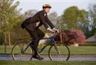 Yes, you can cycle in a suit, just don't forget the trouser clips.