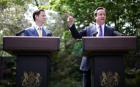 Prime Minister David Cameron (R) and Deputy Prime Minister Nick Clegg hold their first joint press conference in the Downing Street garden