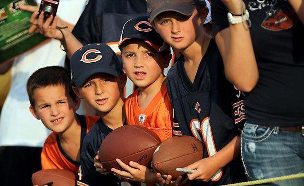 Chicago Bears' fans Jake Hoeppel, 7, Sam Driscoll, 6, Jack Driscoll, 9, Luke Hoeppel, 9, all of Naperville hope for autographs before practice on August 7. (Scott Strazzante, Chicago Tribune)