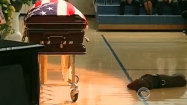 Dog stands by owner at his funeral