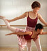 Grandmother helping granddaughter practice ballet