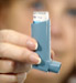 Woman holding an asthma inhaler