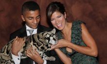 Zoraida Sambolin, right, and son Nicolas Hobbs play with a sixth-month-old clouded leopard at the Friends of Conservation Ball at the Fairmont Hotel in Chicago, Oct. 31, 2011. (Mila Samokhina/for the Chicago Tribune)
