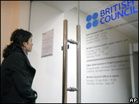 Woman looks at British Council sign