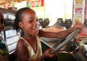 Little girl on bumper car in African amusement park