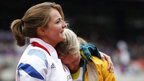 Britain's Goldie Sayers, left, and Australia's Kimberley Mickle embrace during a women's javelin throw qualification round at the London Olympic Stadium, 7 August