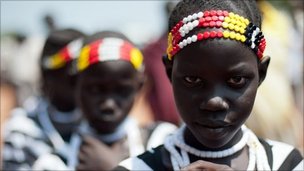 Young Sudanese girls in traditional dress participate in a march organised by the Sudan People"s Liberation Movement (SPLM) in Juba on July 5, 2011 