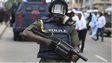 A Nigerian policeman holds a teargas launcher in Lagos on 1 June 2012