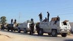 Egyptian security forces stand by their armoured personnel carriers ahead of a military operation in the northern Sinai peninsula on 8 August 