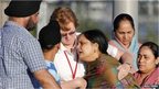 A distraught women is helped to a car outside of the Sikh temple in Oak Creek, Wisconsin 