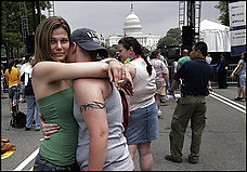 Virginians Brandi Ryman, left, and Breann Settle embrace at the 32nd Capital Pride street festival, the culmination of a week of events.