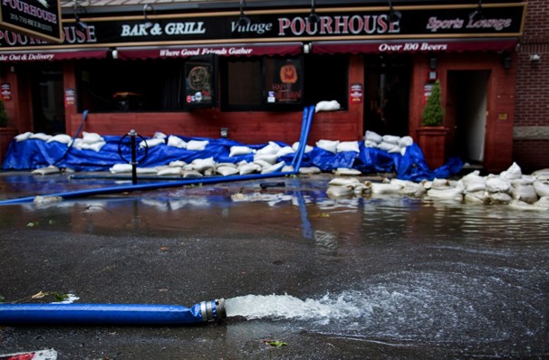 Water is pumped from a restaurant on First Street in Hoboken, N.J.