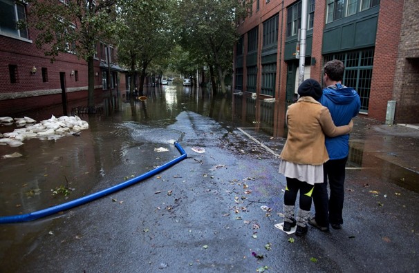 Steve Brett and his wife, Toi Brett, look down First Street at high water near their home in Hoboken, N.J. The Bretts' home was not damaged, but their basement was flooded.