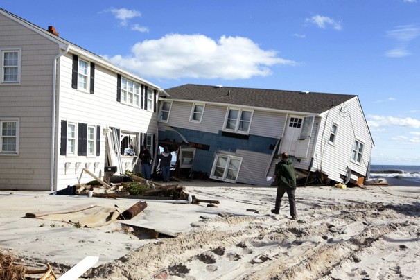 People survey damage to beachfront houses in Long Beach Island, N.J.