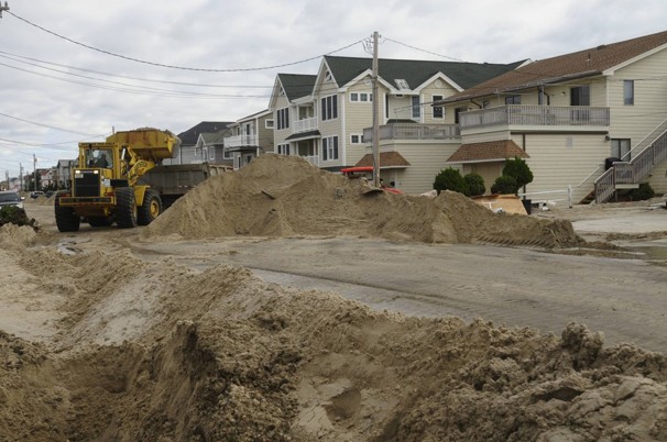 Heavy equipment is deployed to clean up of sand-covered Center Street in Seaside Heights, N.J. Residents in northeast New Jersey who are lucky enough to have a roof after Hurricane Sandy now face a new problem: A heating oil shortage and widespread power outages mean some homes may go cold as the weather turns wintry.