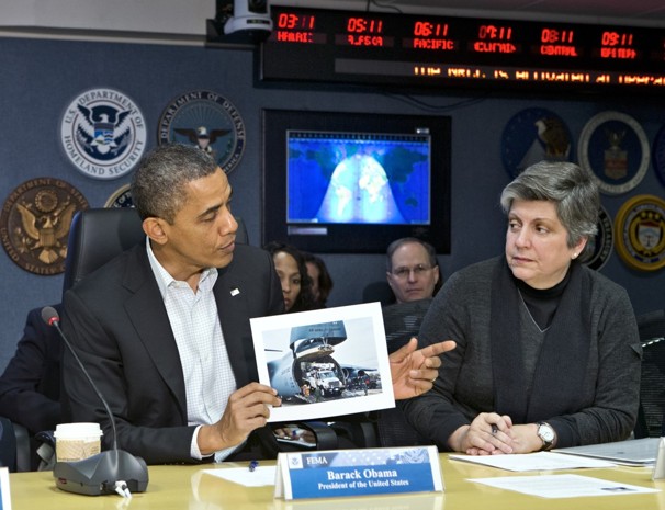 President Obama visits the Federal Emergency Management Agency (FEMA) for an update on the recovery from Hurricane Sandy, which hit New York and New Jersey especially hard, as well as much of the East Coas,t earlier this week. He is joined by Department of Homeland Security Secretary Janet Napolitano, right, as he displays a photo of an Air Force C-17 transporting utility trucks to aid the devastated areas.