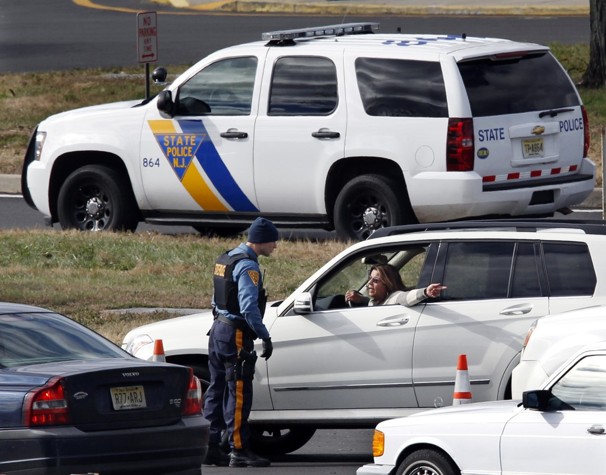 A New Jersey state trooper talks to a motorist at the Thomas A. Edison service area on the New Jersey Turnpike. From storm-scarred New Jersey to parts of Connecticut, a widespread lack of gasoline added to the frustration since Sandy passed through the area.