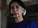 Aung San Suu Kyi speaks to villagers near the copper mine project site in northern Burma, March 13, 2013.