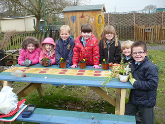 Comberbach Primary School Year 1 pupils with their Mini-pots of Care fundraising for Marie Curie