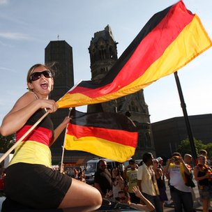 A German football supporter waves national flags on top of a car on the Kurfuerstendamm, Berlin.