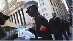 US Marine Lance Cpl Torffic Hassan from Ghana looks over his citizenship certificate on Wall Street on 22 March 2013
