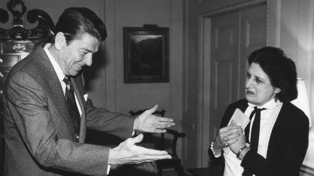 President Ronald Reagan greets United Press International (UPI) White House reporter Helen Thomas on April 22, 1981 in the Treaty Room at the White House in Washington. Reagan granted an interview with the wire services and described the March 30 attempt on his life. Thomas died Saturday at age 92. (UPI Photo/Don Rypka/Files)